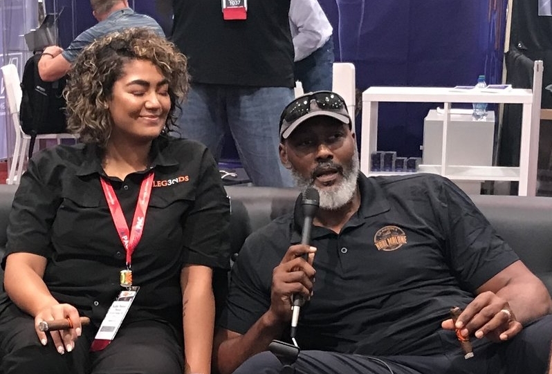  Karl Malone talks about his new cigar —&nbsp;Barrel-Aged by Karl Malone —&nbsp;with his daughter Kadee, who is co-owner of Legends Cigar and Vape in Ruston, Louisiana. 